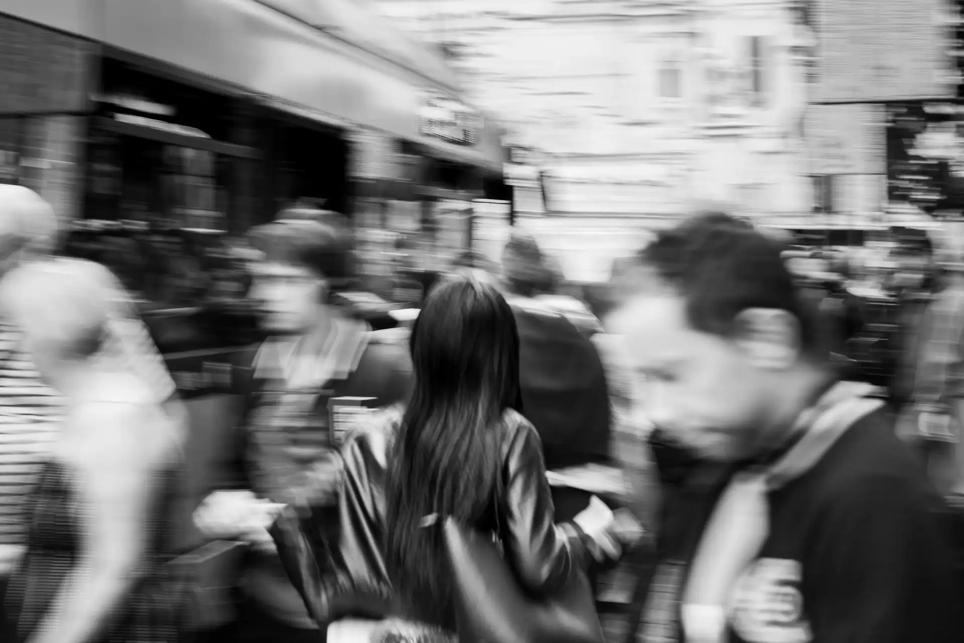 people getting off and on bus - photo with motion blur